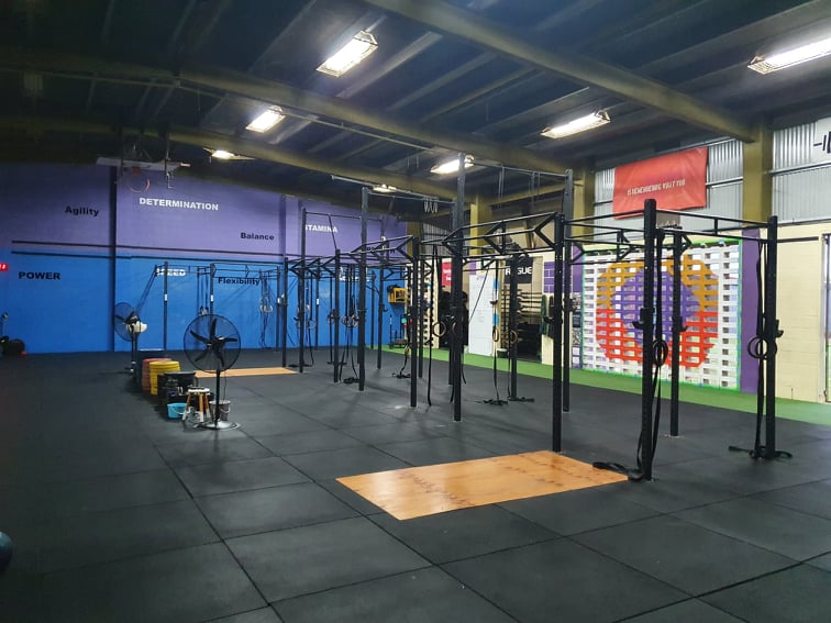 Storm's equipment area with rigs, weights and cardio machines ready for class