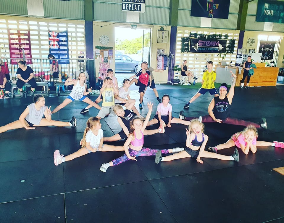 Kids stretched out on the mats during Little Bootcamp