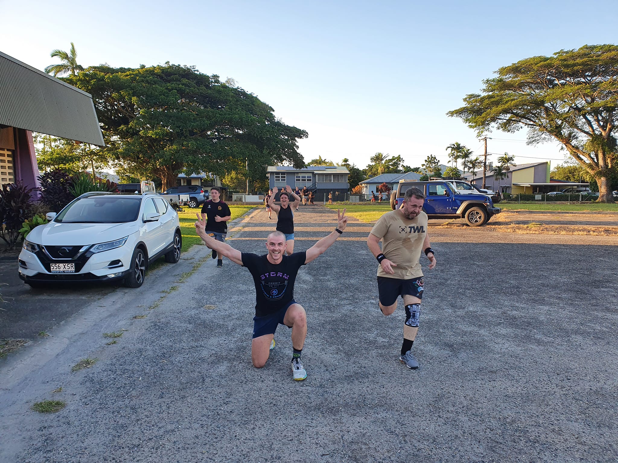 Storm members running together along the road at sunrise on a group fun run