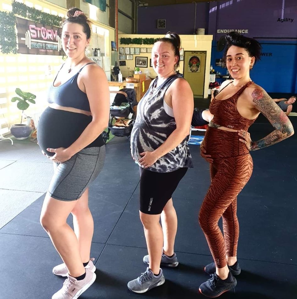 Three expecting mums training together at the gym