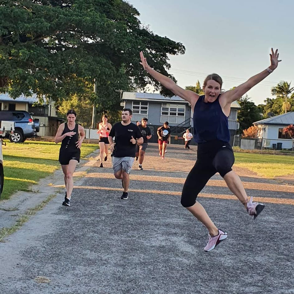 Members jumping and laughing at the end of a group run